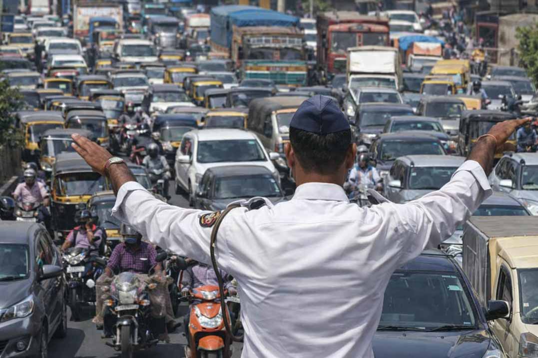 Traffic police officer managing heavy traffic congestion on a busy road in Bhopal during route diversion.